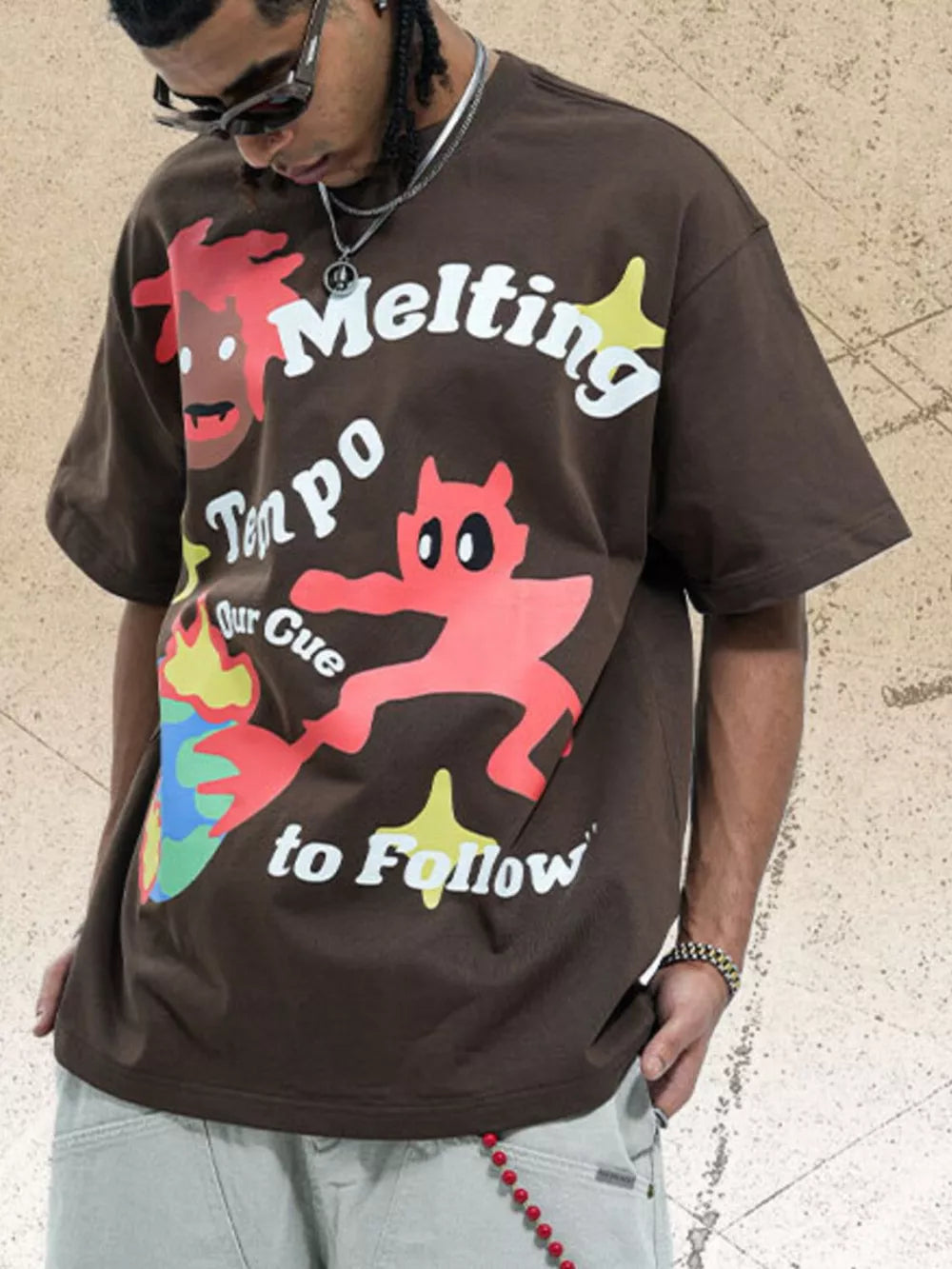 Brown cotton oversized t-shirt with bold graphic print and text.