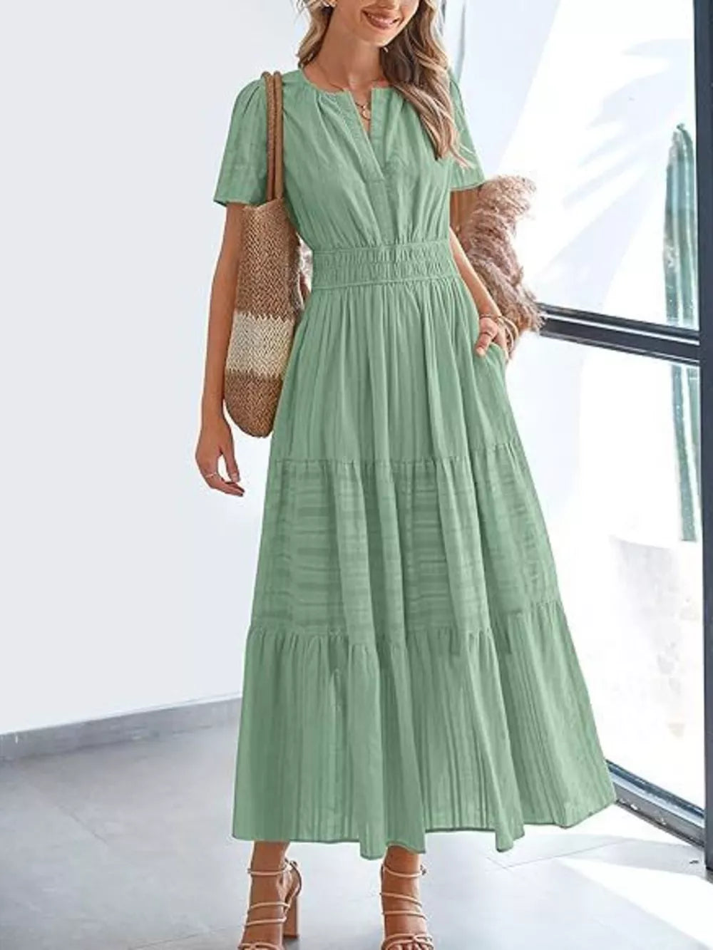 Moss green V-neck tiered midi dress with smocked waist and short sleeves.
