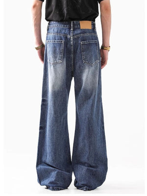 Relaxed fit washed denim jeans for men, 100% cotton, with a wide leg and distressed details.