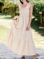 Apricot gingham midi dress with ruffled square neck and smocked bodice.