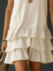 Tiered ruffled hem white dress with V-neck and airy, casual style.