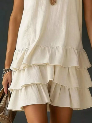 Tiered ruffled hem white dress with V-neck and airy, casual style.