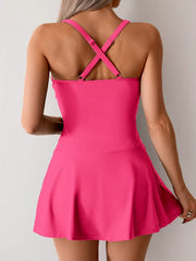 Rose Red one-piece swimsuit with criss-cross straps and a skirted bottom.