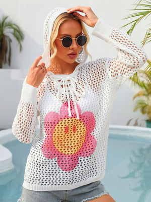 White crochet lace-up hoodie with a pink and yellow smiley face flower graphic.