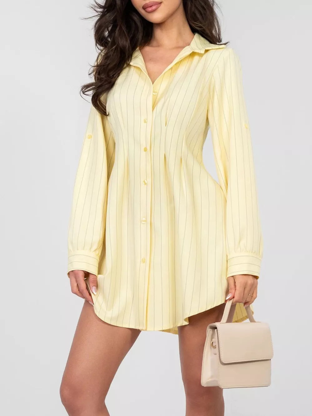Light yellow striped mini dress with button detail and long sleeves.