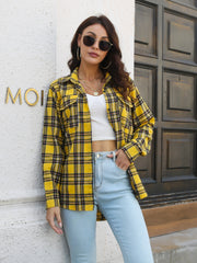Yellow plaid overshirt with flap pockets worn open over a white crop top and light wash jeans.