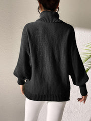 Black turtleneck sweater with dolman sleeves and ribbed cuffs.