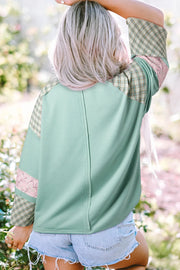 Patchwork heart raglan top in gum leaf green with plaid and floral sleeve details.