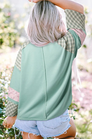 Patchwork heart raglan top in gum leaf green with plaid and floral sleeve details.
