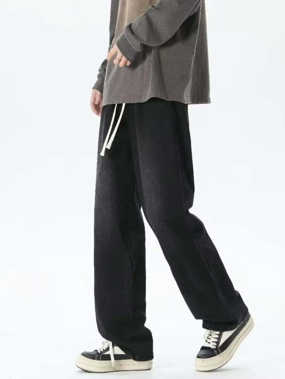 Men's relaxed fit jeans with gradient wash and white drawstring waist.