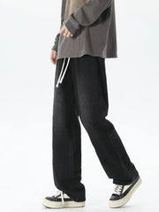 Men's relaxed fit jeans with gradient wash and white drawstring waist.
