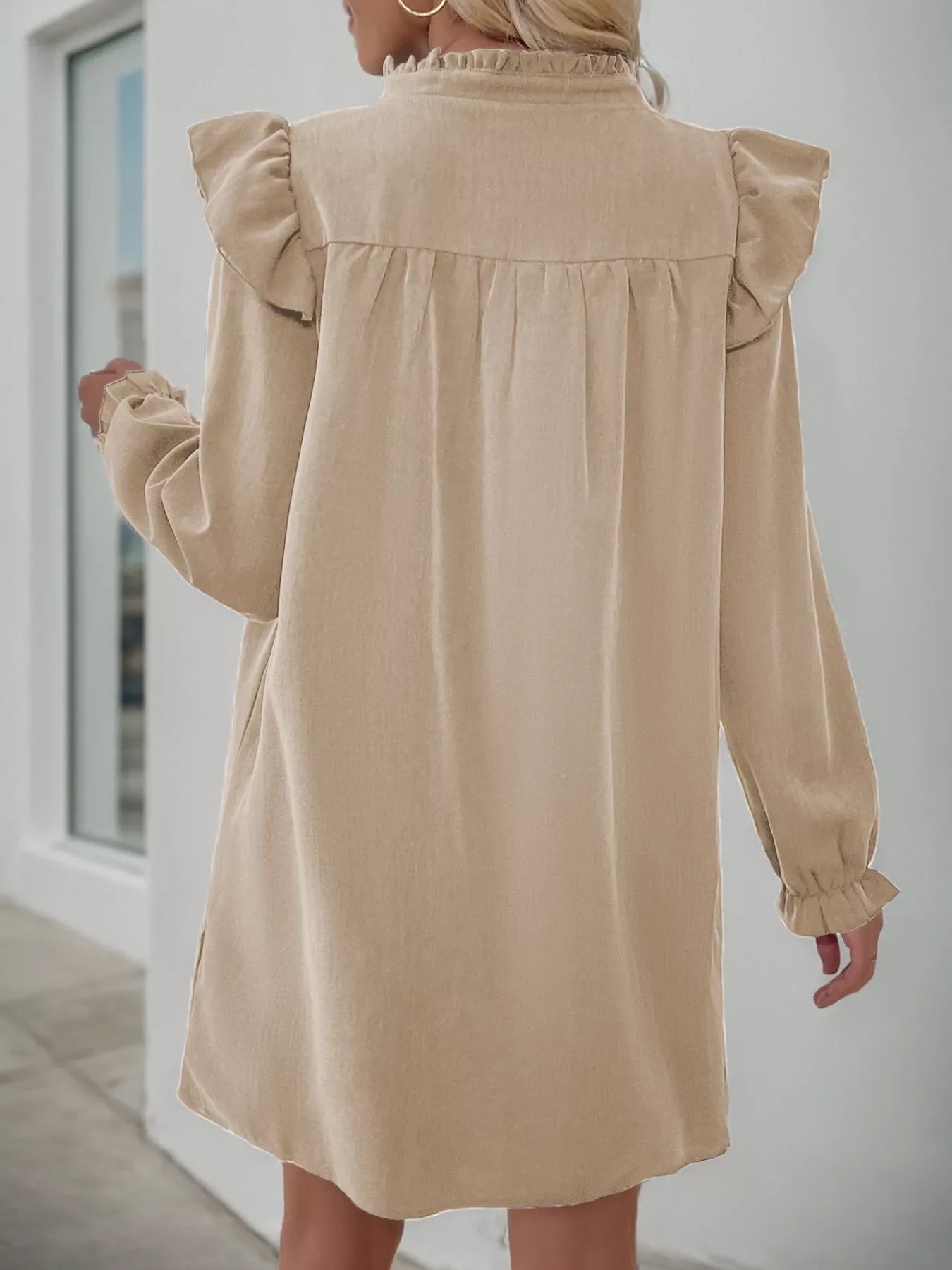 Apricot cotton blend dress with ruffled notched sleeves and hem.