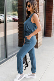 Peacock Blue relaxed drawstring waist jumpsuit with pockets, sleeveless, and cinched ankles.