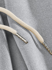 Light gray men's sweatpants with drawstring detail and metal aglets.