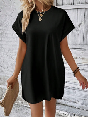 Black relaxed tee dress with cuffed sleeves and crew neck, styled casually.