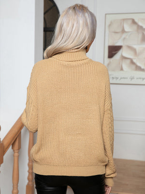 Khaki acrylic cable knit turtleneck sweater with textured details.