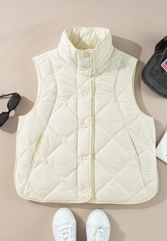 Ivory quilted stand collar vest with snap closure and side pockets.