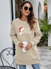 Beige Christmas graphic tunic sweatshirt with Santa hat and "Believe" text, crewneck, long sleeves.