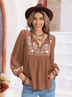 Camel embroidered yoke blouse with gathered bodice and tie neck.
