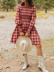 Red plaid cotton mini dress with smocked bodice, puff sleeves, and ruffled cuffs.