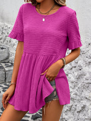 Textured babydoll blouse in deep rose with flutter sleeves and a tiered hem.