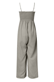 Gray smocked bodice palazzo jumpsuit with adjustable spaghetti straps and wide legs.
