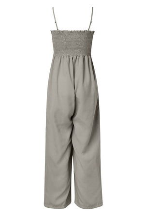 Gray smocked bodice palazzo jumpsuit with adjustable spaghetti straps and wide legs.