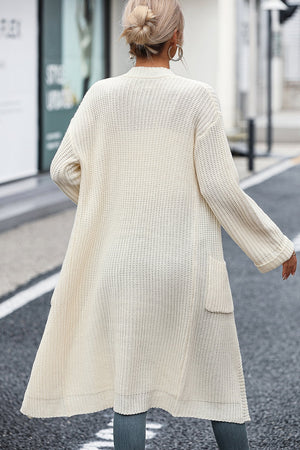 Cream longline knit cardigan with pockets, acrylic, open front, casual style.