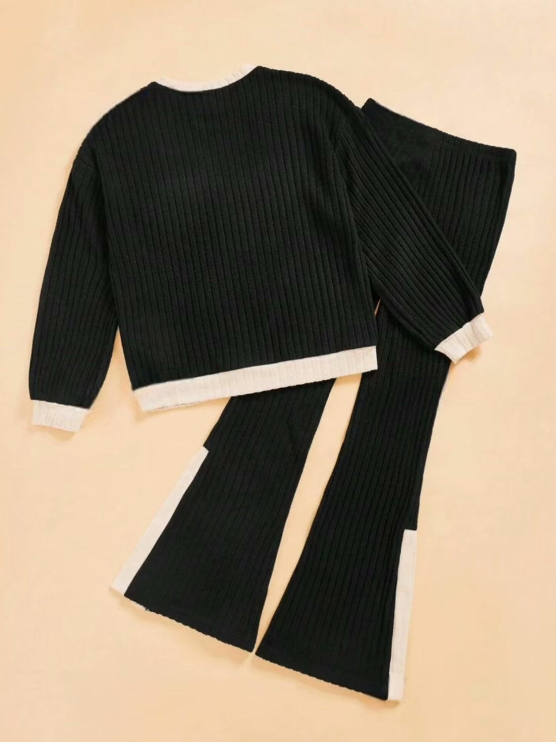 Black ribbed knit loungewear set with contrast trim and slit hem pants