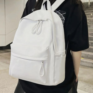 White leather backpack with front zip pocket and dual zip main compartment.