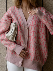 Dusty pink acrylic geometric knit button-up cardigan with V-neck and pockets.