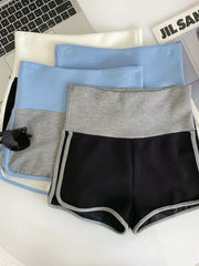 Black athletic shorts with gray contrast trim and waistband, shown with other colors.