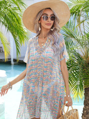 Openwork knit beach cover-up with V-neck and side slits in a pastel multicolor stripe pattern.