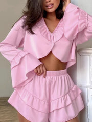 Pink ruffled V-neck pajama set with shorts and bell sleeves.