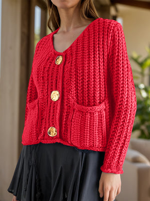 Chunky knit red cardigan with statement buttons and pockets.