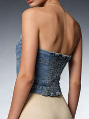 Structured denim tube top with smocked back and button detail, cotton blend.