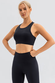 Black asymmetric cutout sports bra with racerback and high-waisted leggings.