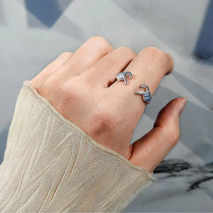 Silver ring with engraved heart hands detail, adjustable open design