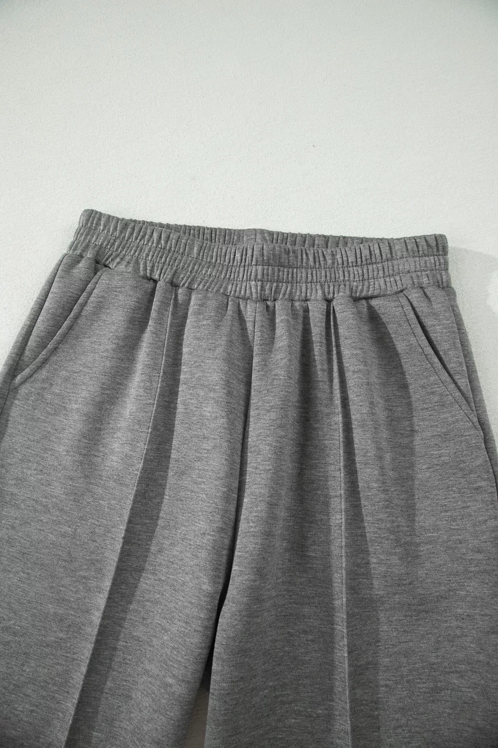 Chic dark gray wide-leg pants with elastic waistband and side pockets.
