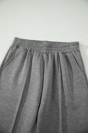Chic dark gray wide-leg pants with elastic waistband and side pockets.