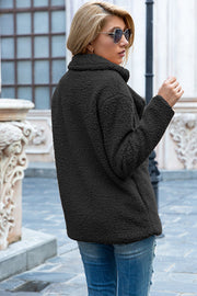 Black teddy pea coat with a double-breasted closure and notched lapels.