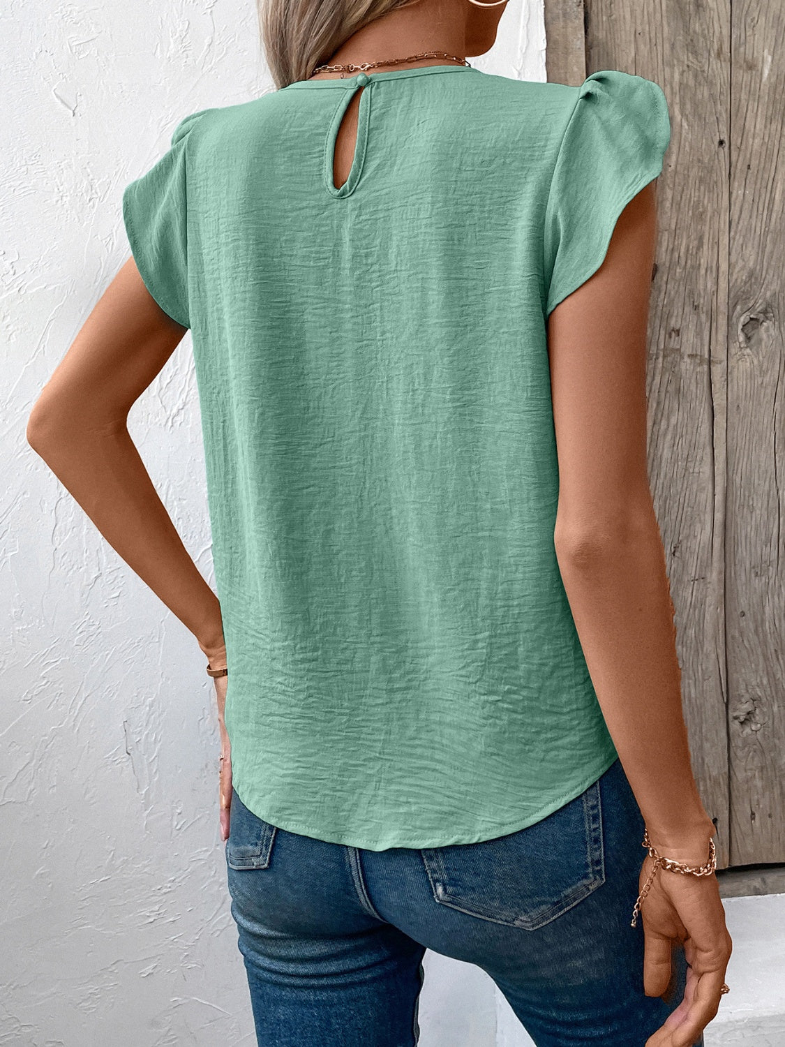 Pleated yoke flutter sleeve blouse in Gum Leaf green with keyhole back detail.