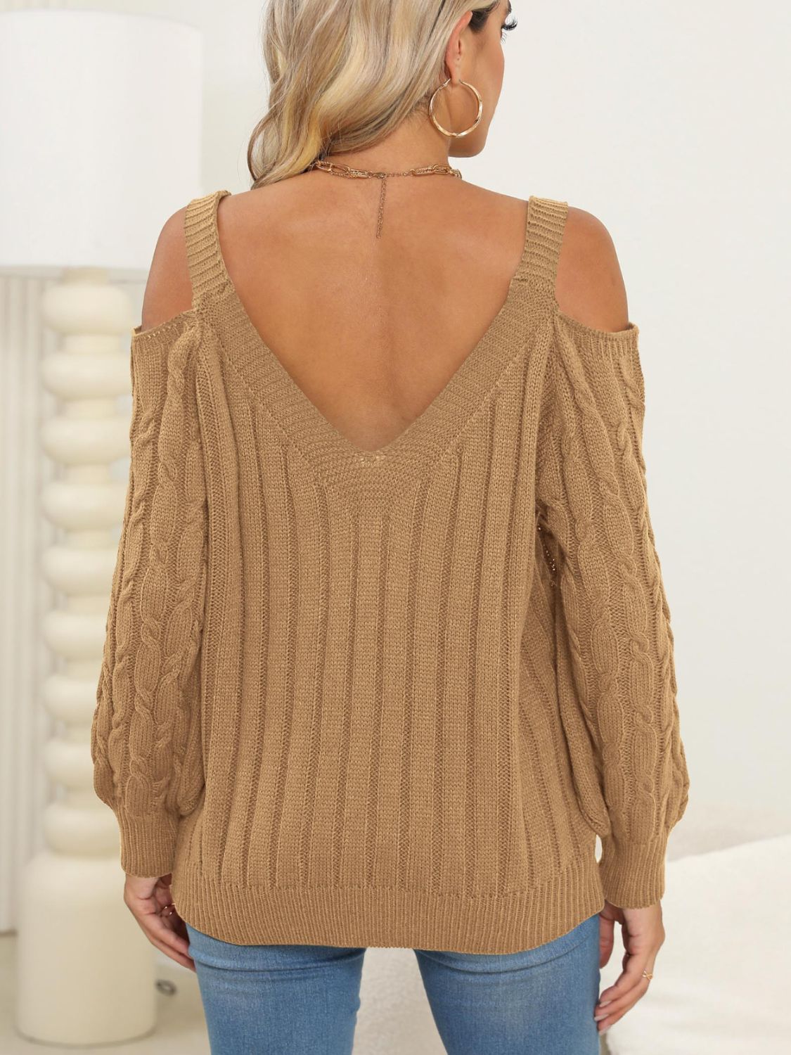 Camel cable knit cold shoulder sweater with V-neck and balloon sleeves.