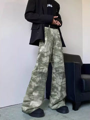 Abstract print wide-leg jeans in green and white camouflage with black embroidered detail.