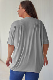 Light gray ribbed batwing cardigan with short sleeves and a drape front.