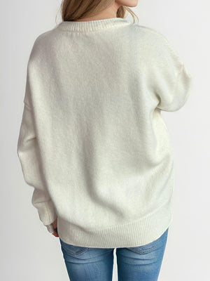 Oversized white crewneck knit pullover sweater with ribbed cuffs and hem.