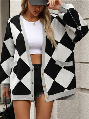 Black and white argyle knit oversized cardigan with pockets and grey trim.