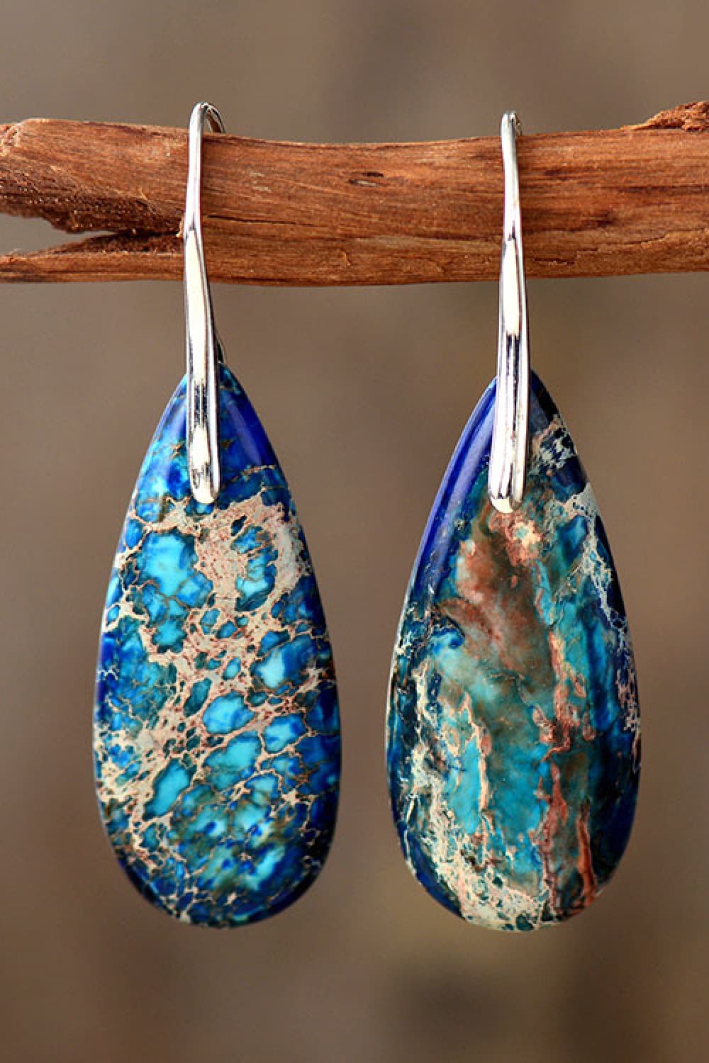 Ocean Jasper dangle earrings in blue/silver with teardrop shape and natural stone pattern.
