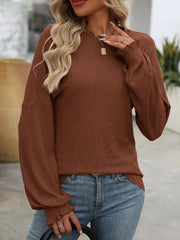 Dark brown ribbed knit blouse with ruffled cuffs and balloon sleeves.