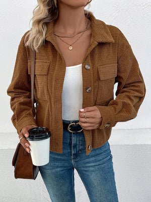 Textured corduroy cropped shirt jacket in camel with button front and chest pockets.